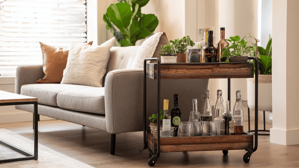 DIY bar cart with shelves and wheels placed in a real living room.
