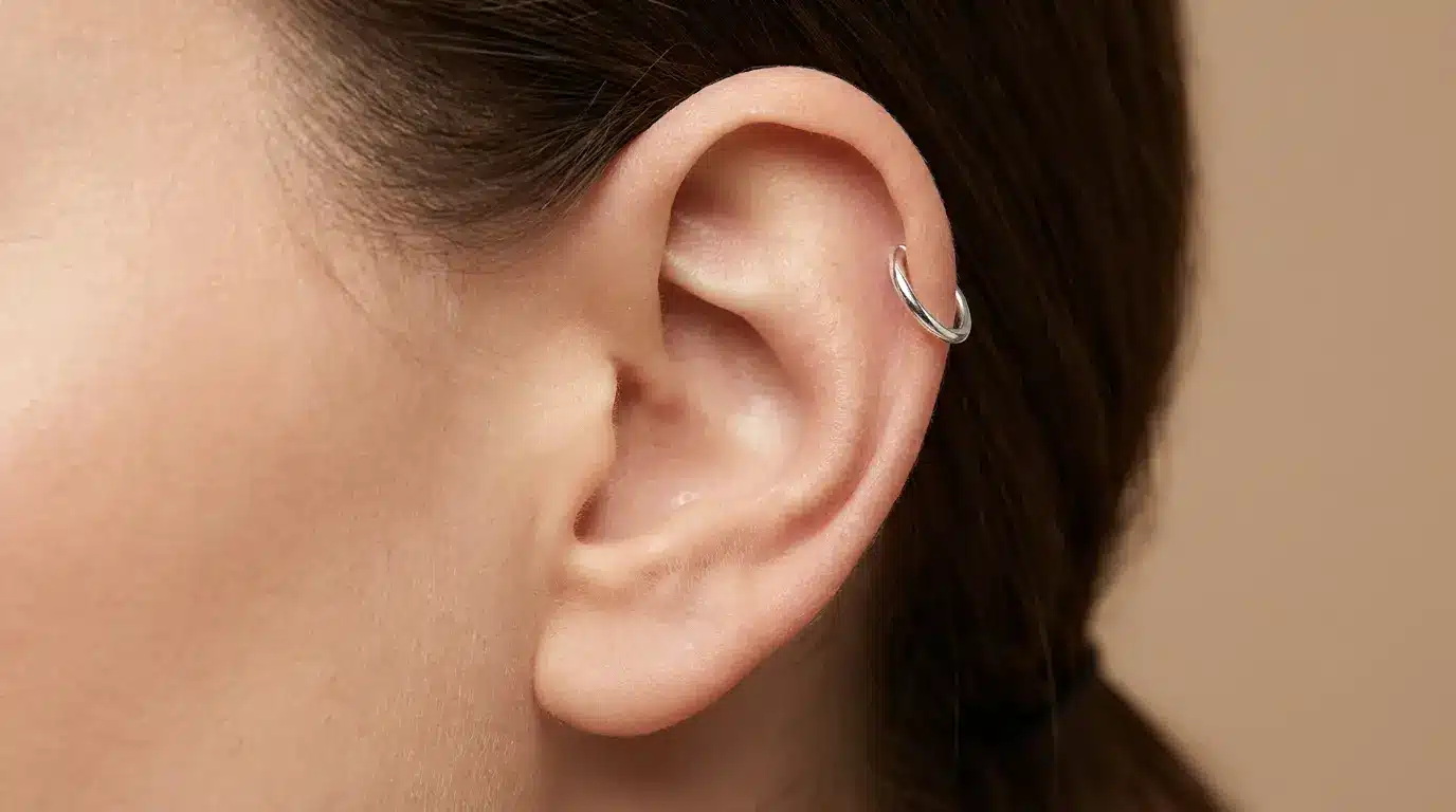 Helix cartilage piercing with a small hoop