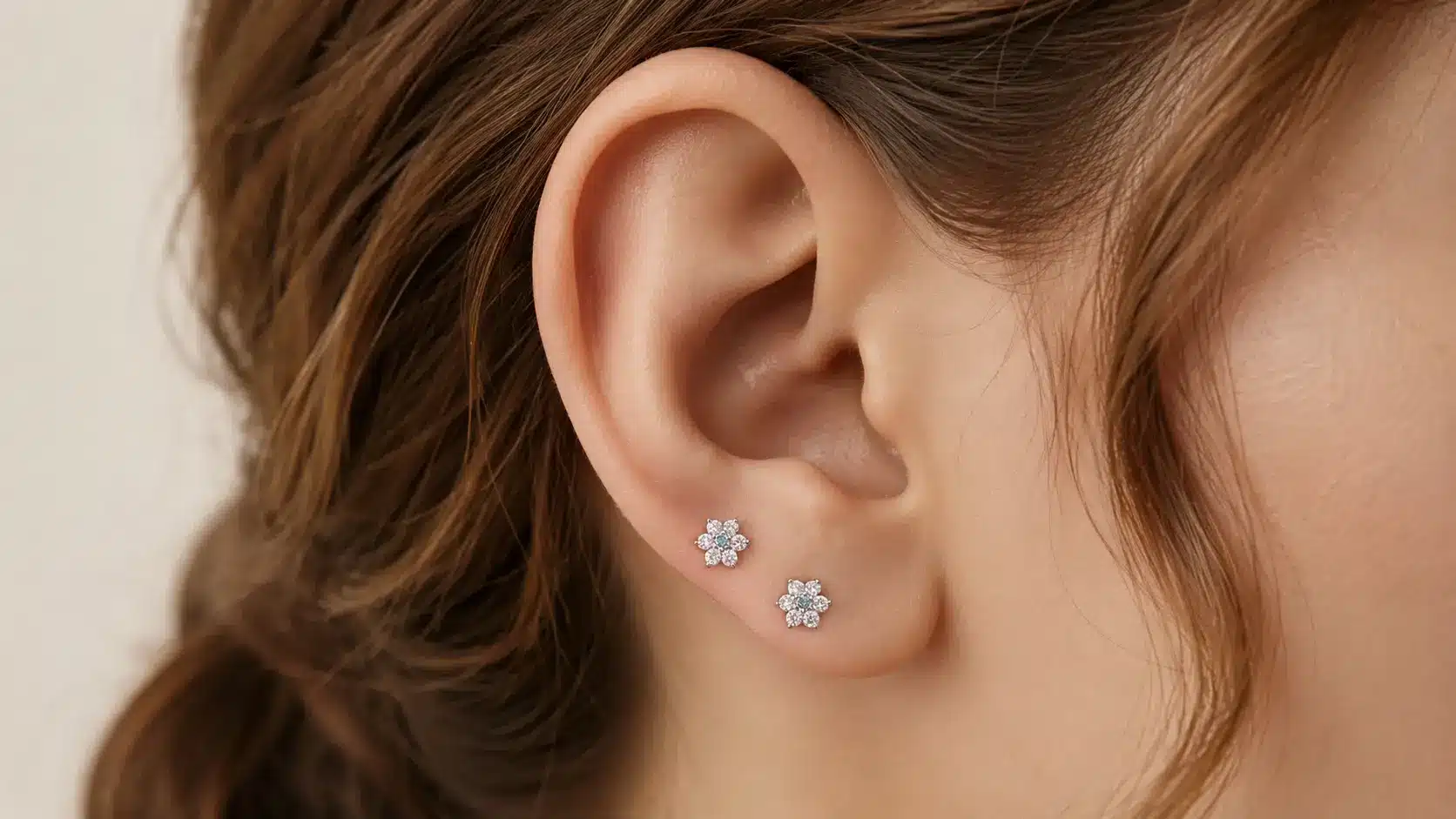 High lobe piercing with two floral stud earrings
