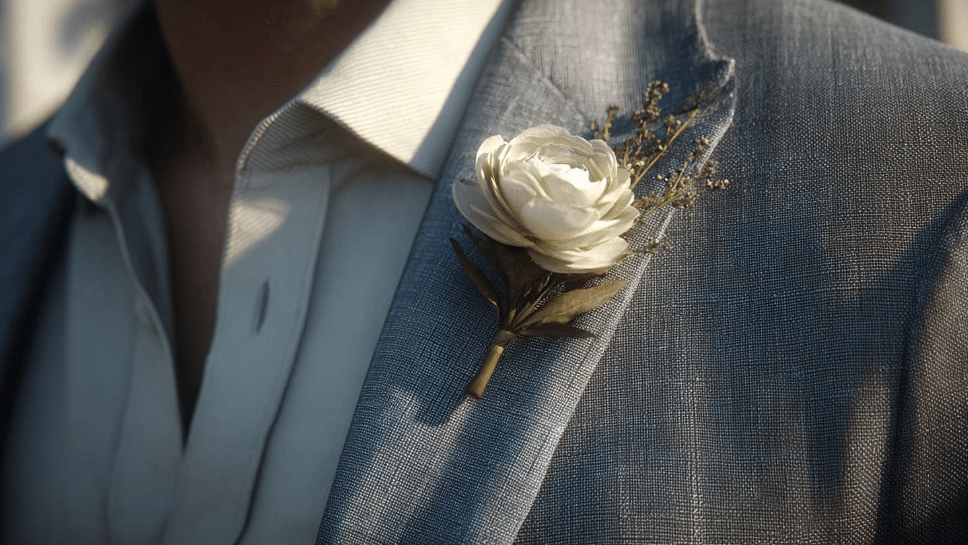 Man wearing a suit with a single stem boutonniere on his left lapel. (1)