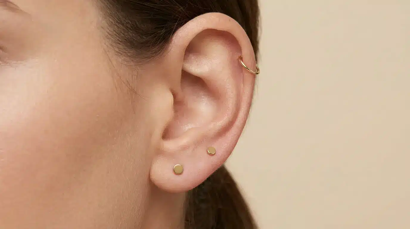 Minimalist ear stack with gold studs and helix hoop