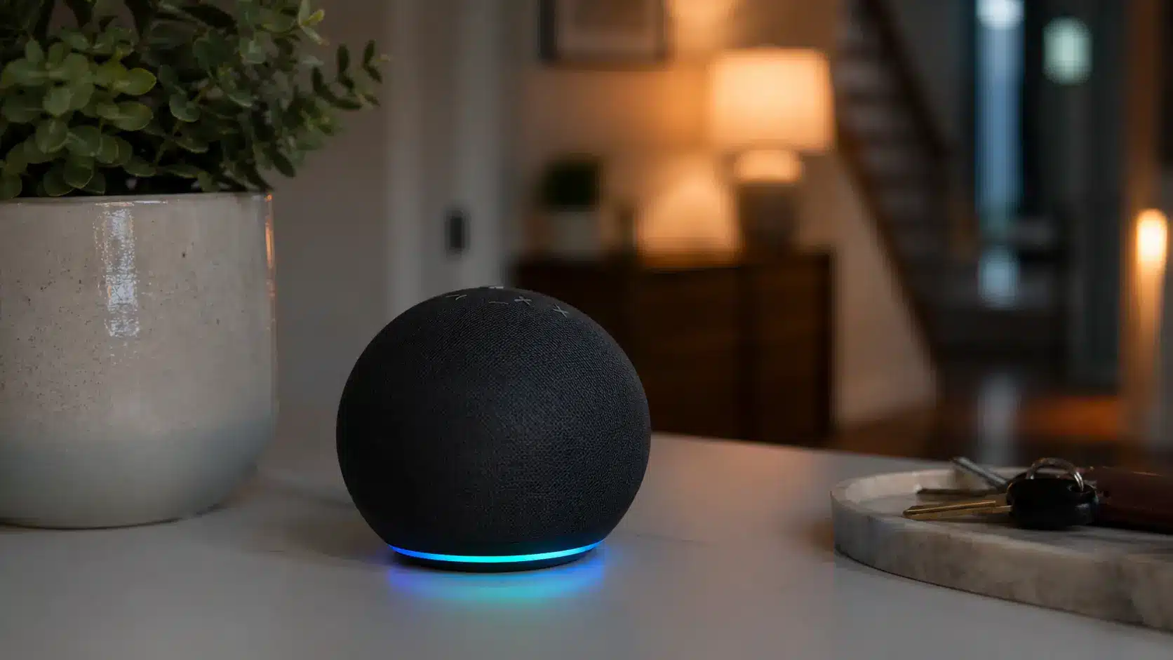 Smart Home Hub with glowing ring on a table next to a plant and key tray in a cozy interior.