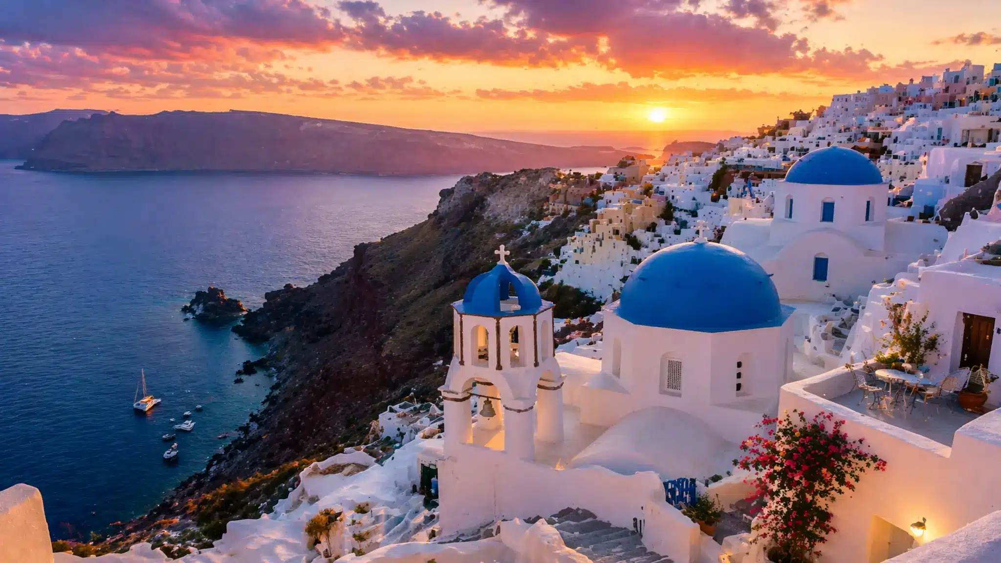 Sunset view of Santorini's whitewashed buildings, blue-domed churches, and serene Aegean Sea