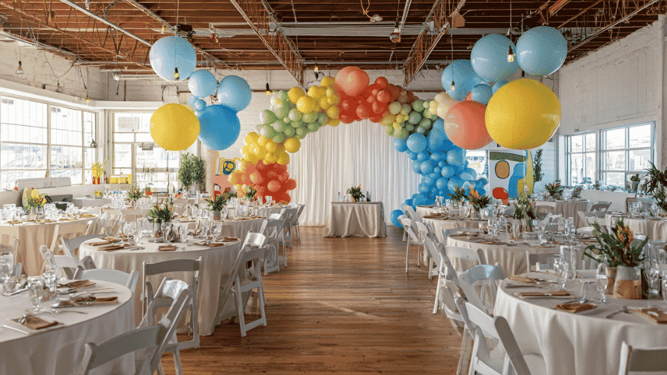 Wedding reception with balloon backdrop photo area and complete seating layout