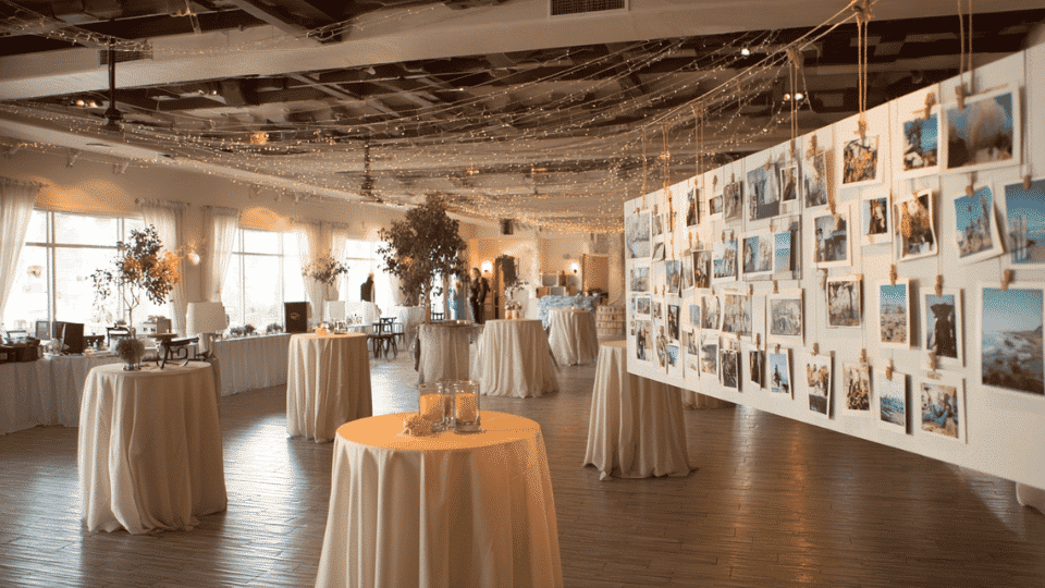 Wedding reception with photo display wall and full seating arrangement