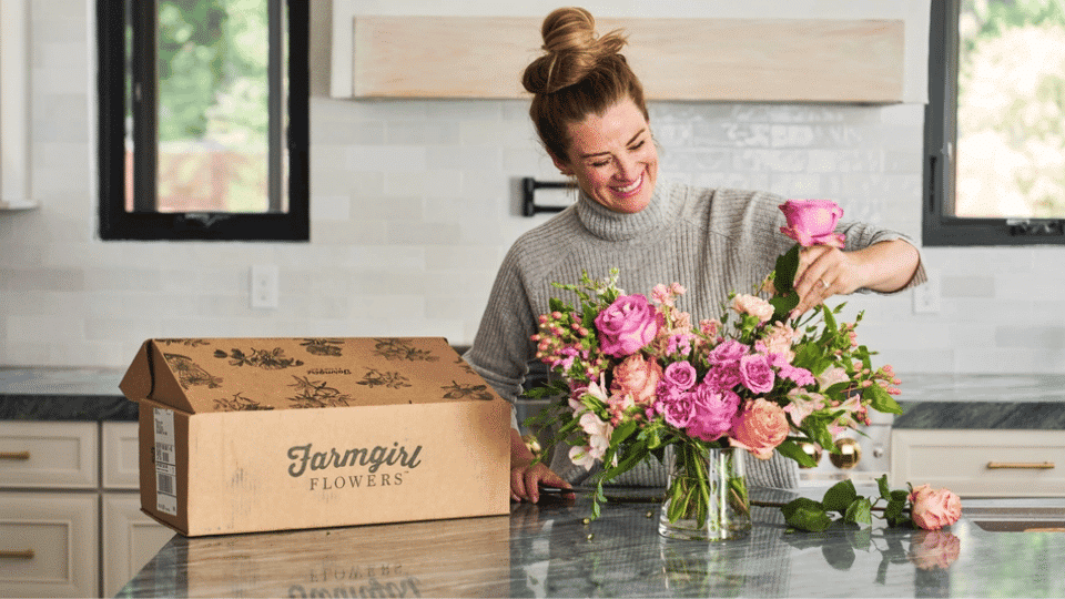 a woman making a flower bouquet by using the flower arrangement kit by farmgirl flowers