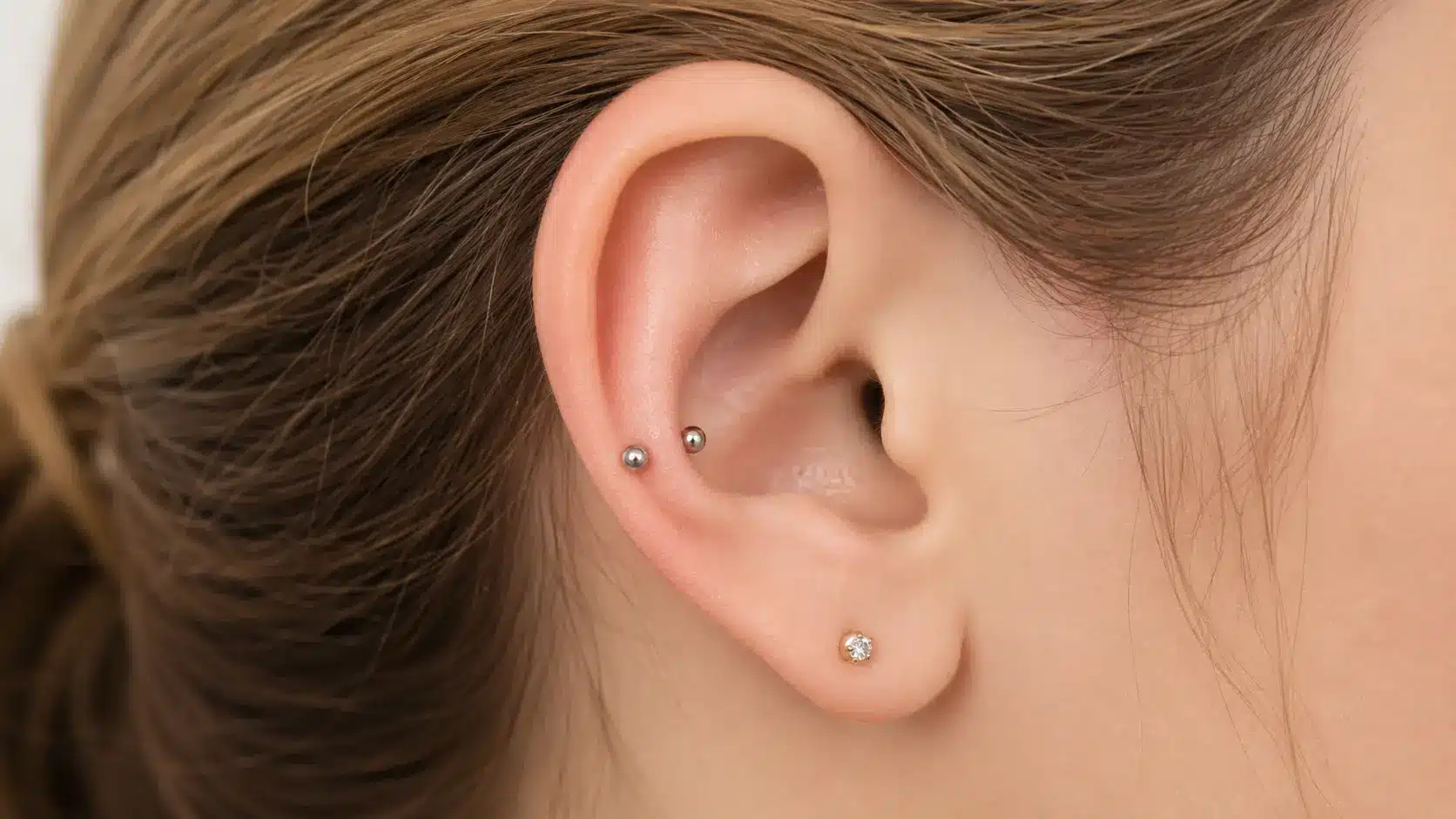snug piercing with double silver studs