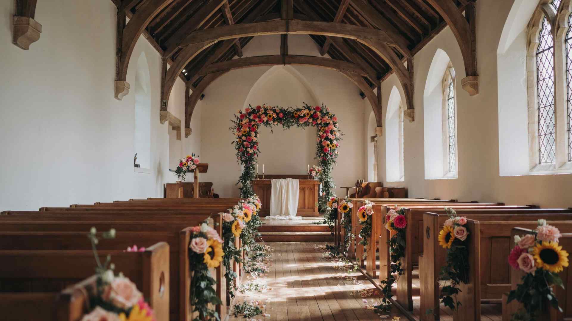 Bright summer flowers decorating a church wedding ceremony