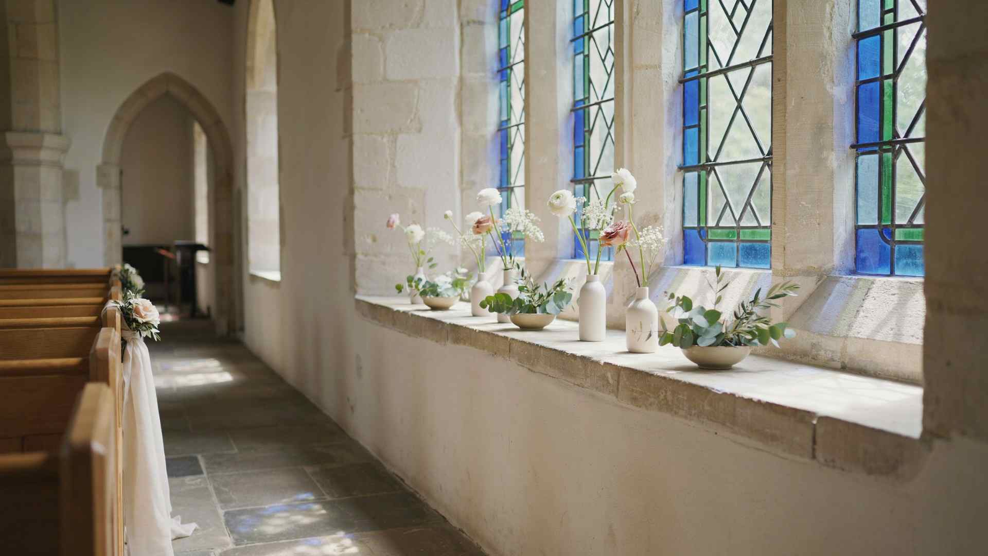 Greenery and small flowers decorating church window ledges