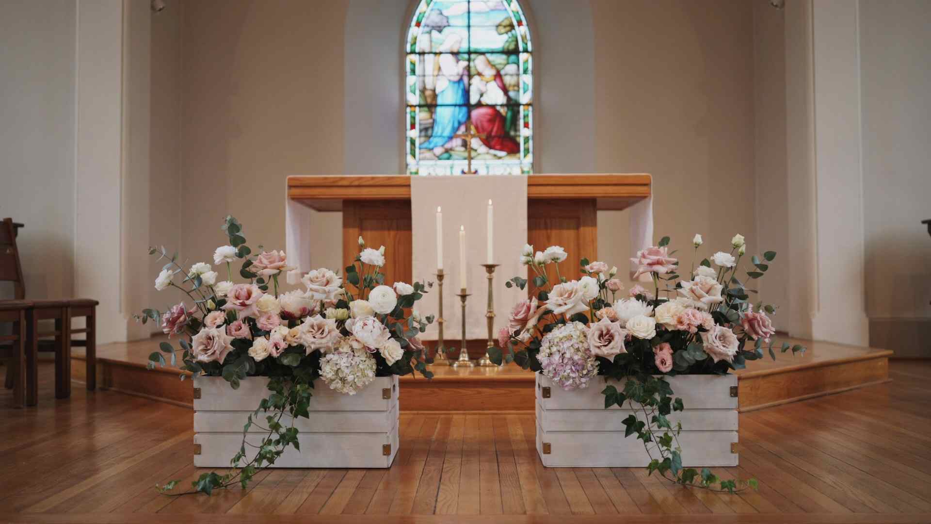 Lightweight flower boxes decorating a church wedding ceremony