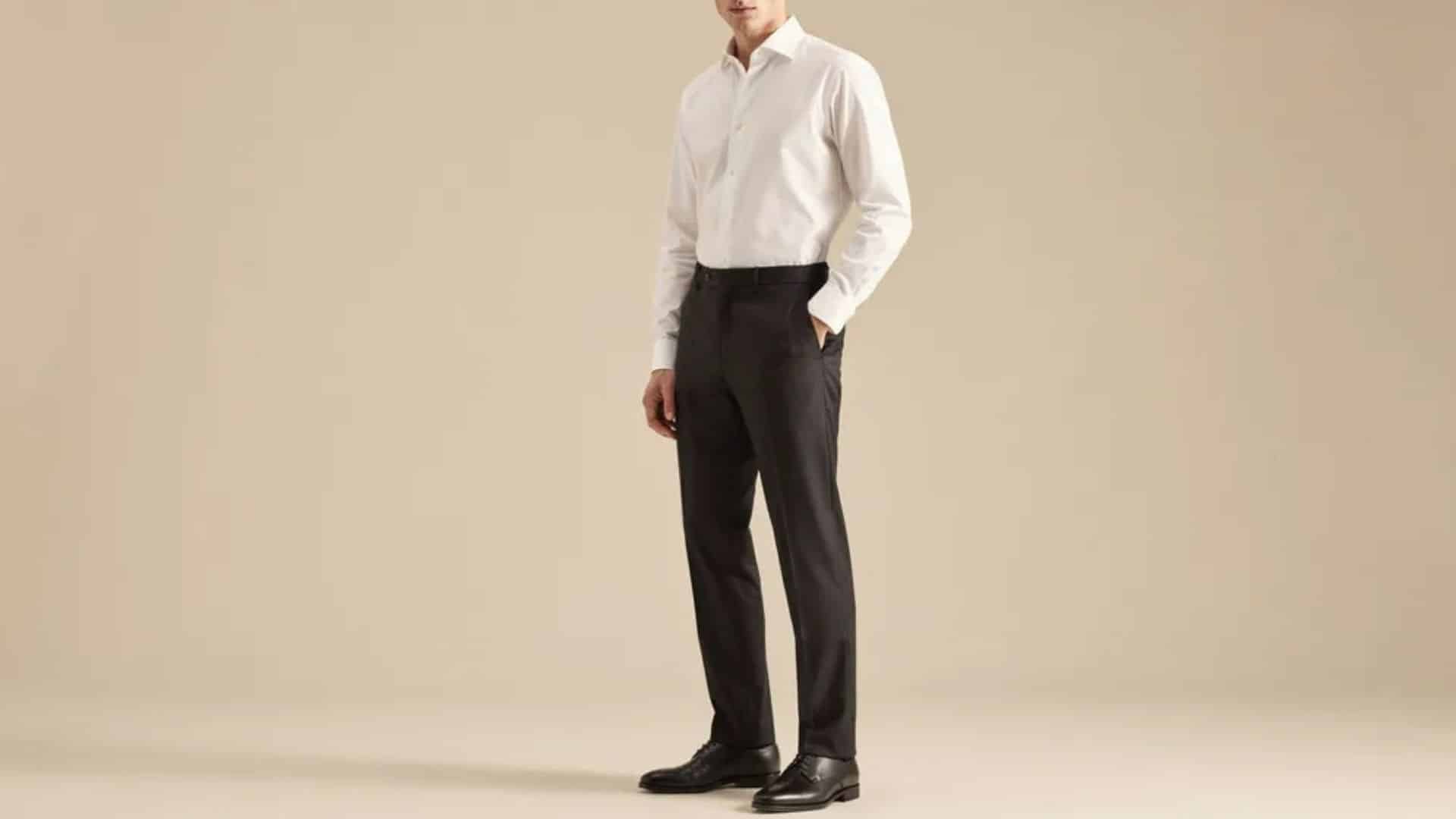 Man wearing a crisp white dress shirt with classic black dress pants for an elegant wedding style