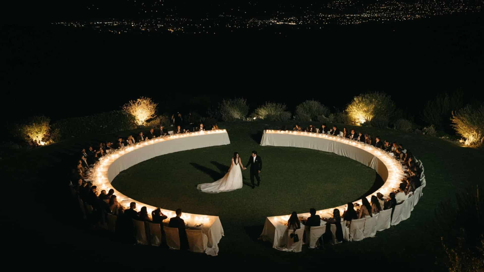 Non traditional wedding ideas featuring an outdoor countryside ceremony with rustic seating, floral aisle, and open field views