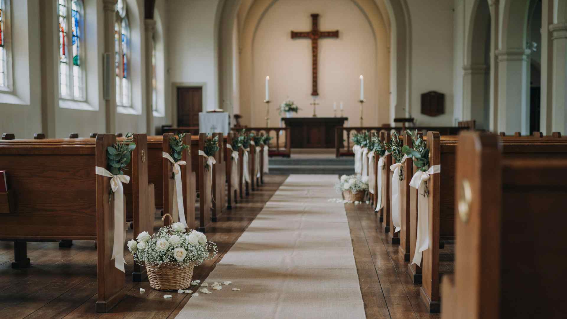 Ribbon reserved row markers on church wedding pews
