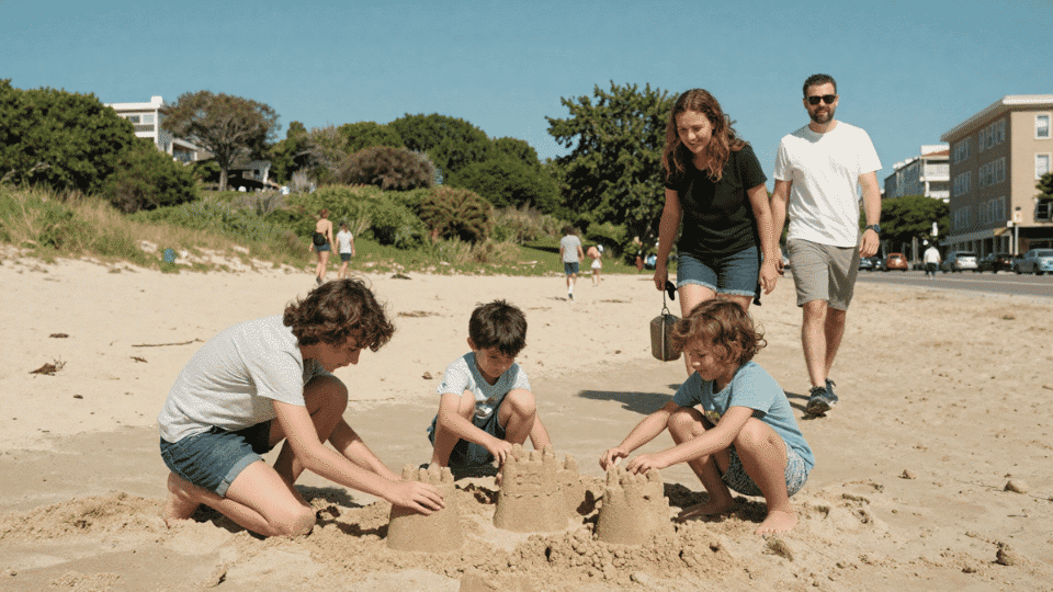 Family of four enjoying a sunny vacation at the beach and park, kids playing and parents smiling.
