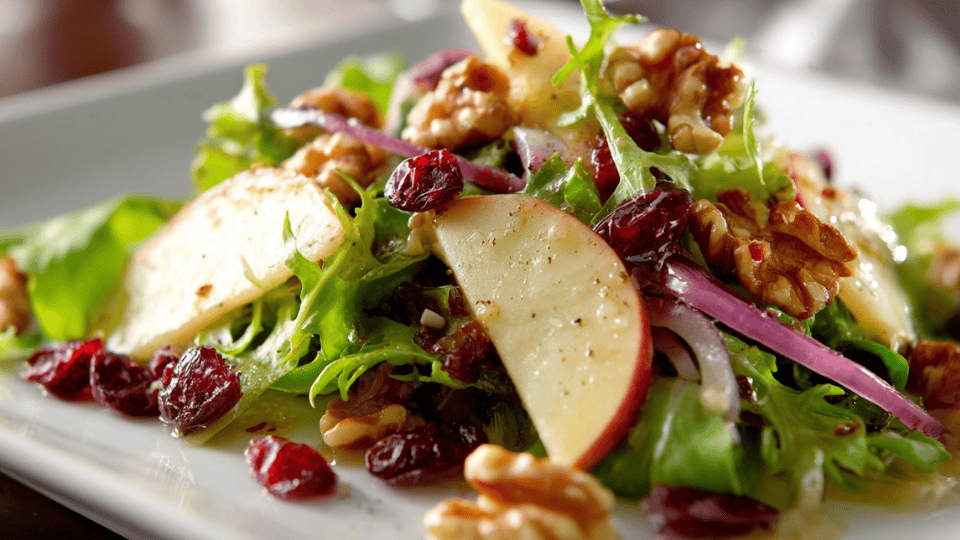 Apple walnut salad with mixed greens, cranberries, and light dressing