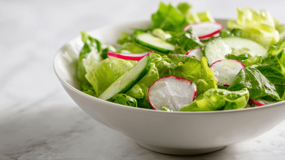 Green salad with lettuce, cucumber, radish, and lemon dressing