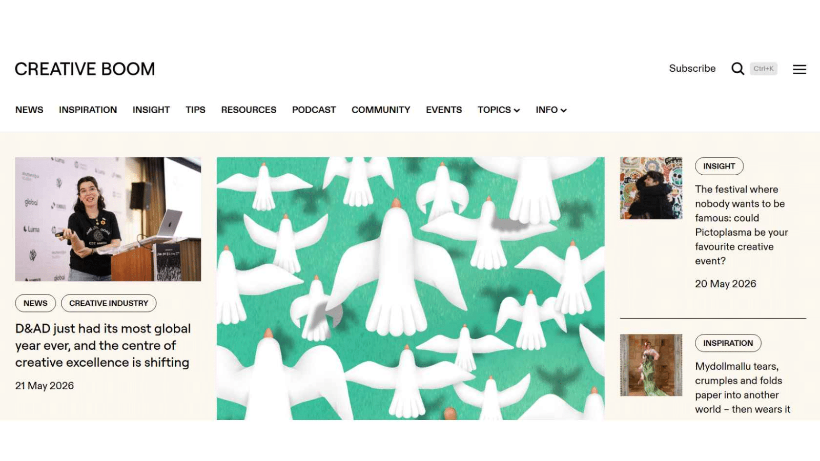 Creative Boom homepage showing a female speaker at a podium, stylized white doves illustration, navigation menu for news, inspiration, and community features.