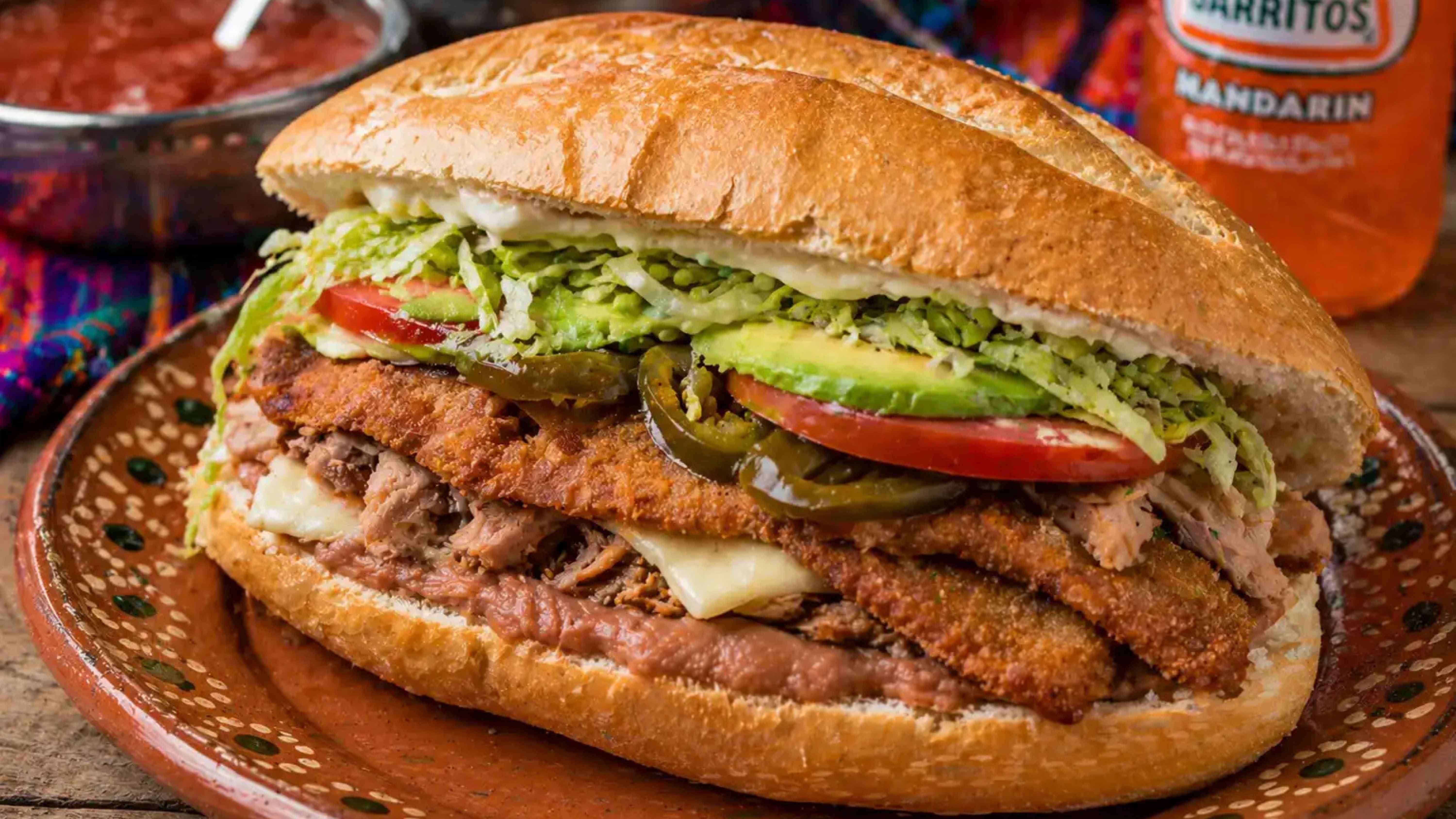 Mexican torta sandwich packed with savory fillings and served as a hearty street food meal.